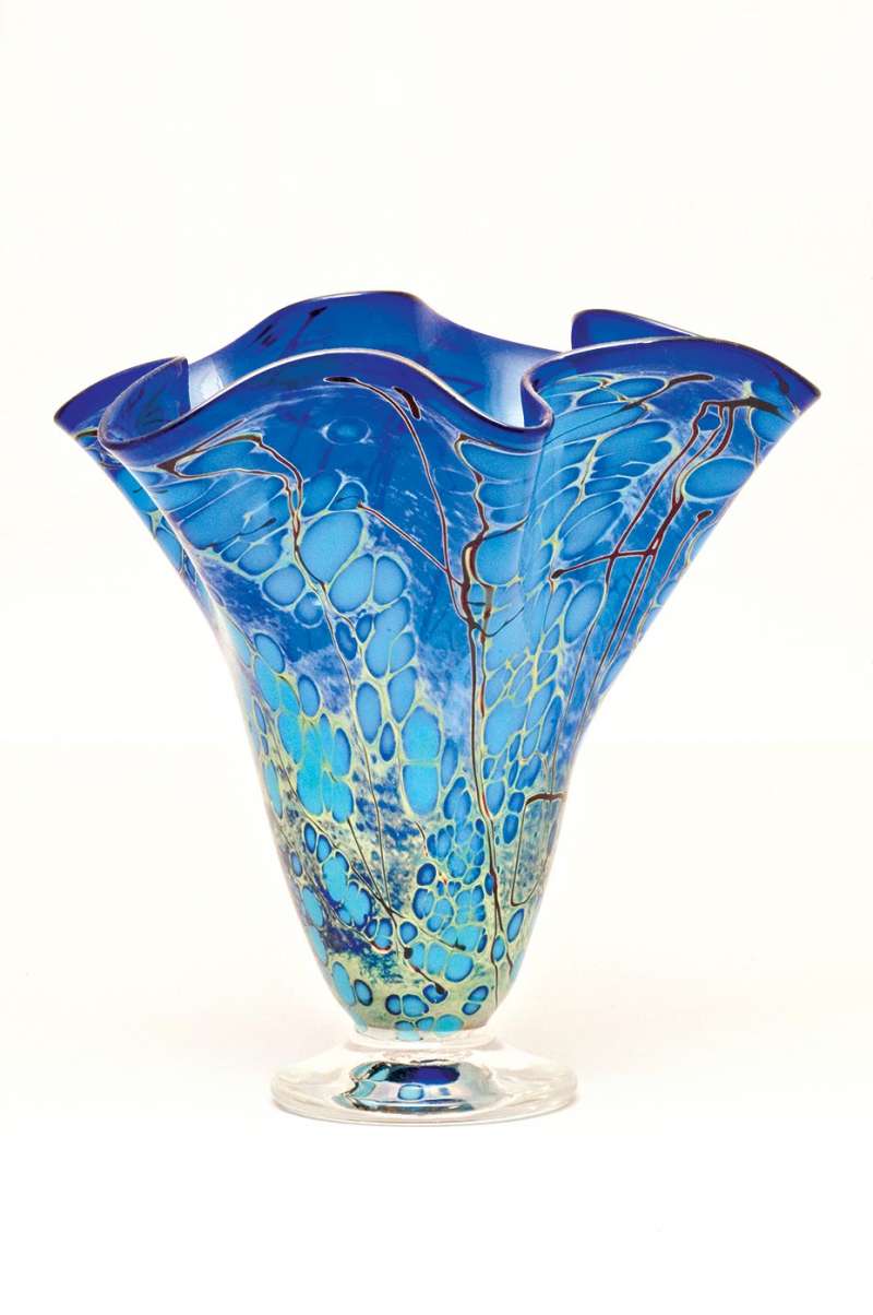 Consumer product photography of a gorgeous hand-blown glass vase in blue with green and teal.